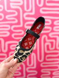 Leopard print flat with a strap across the top of the foot.