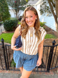 A beige and white vertically striped sleeveless sweater top