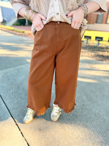 These brown pants feature a flattering high-rise fit with a relaxed wide-leg silhouette and the sweetest ruffle detail at the hem. 