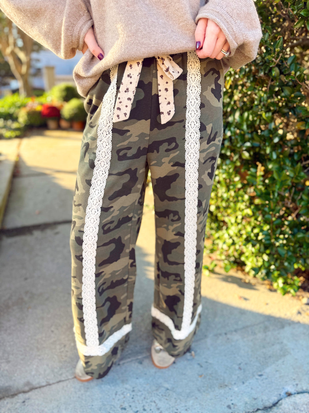 Featuring a classic olive camouflage print, these relaxed wide-leg pants are trimmed with cream crochet lace for the prettiest unexpected contrast.