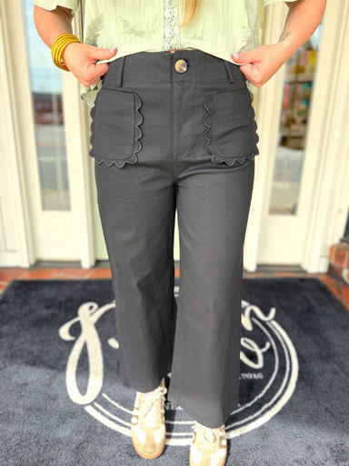 Black cropped pants with scallop pocket detailing.