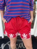red shorts with white flowers