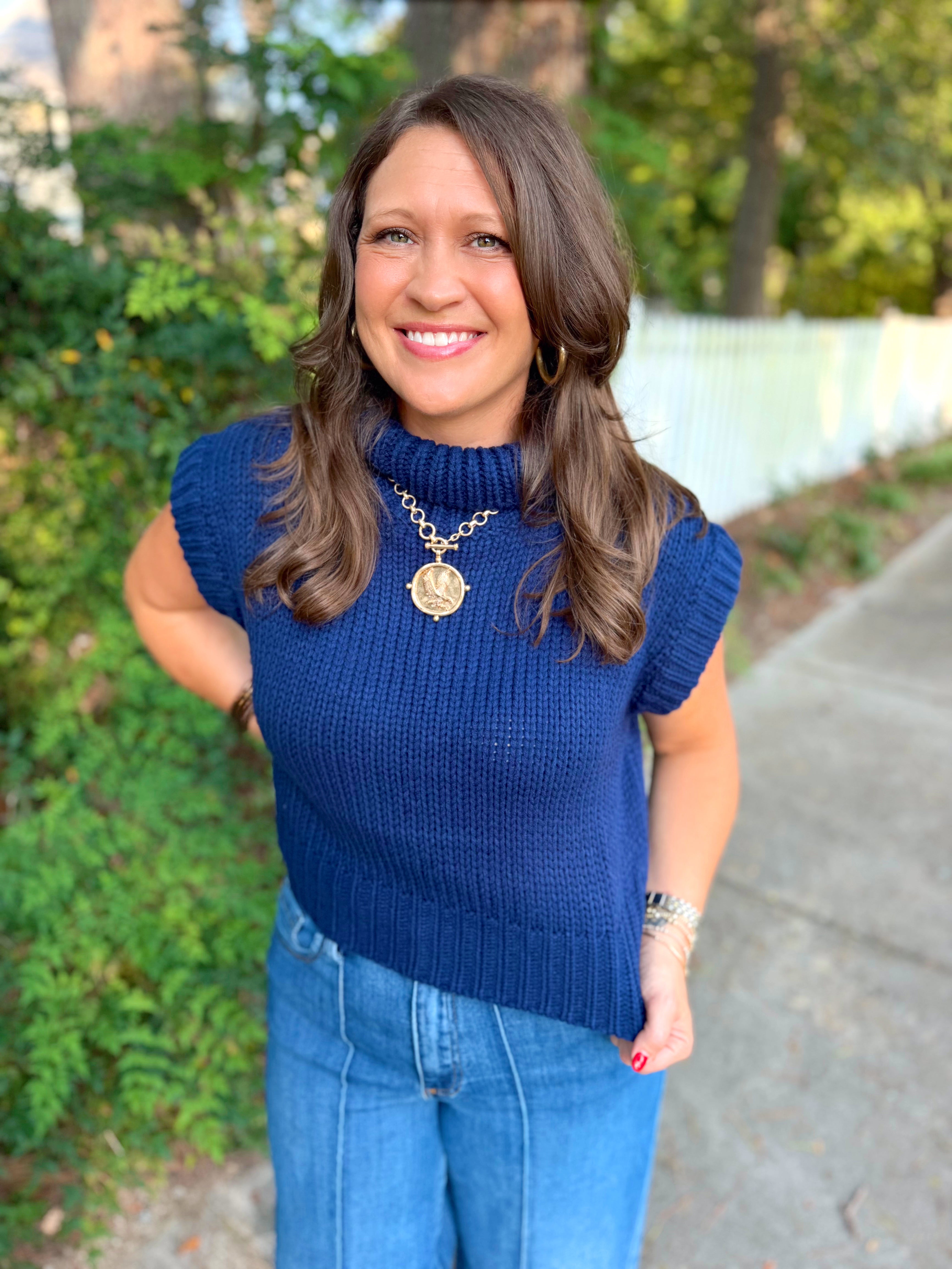 A Navy blue knit mock neck top with cap sleeves