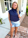 A navy blue sleeveless mock-neck balloon top.