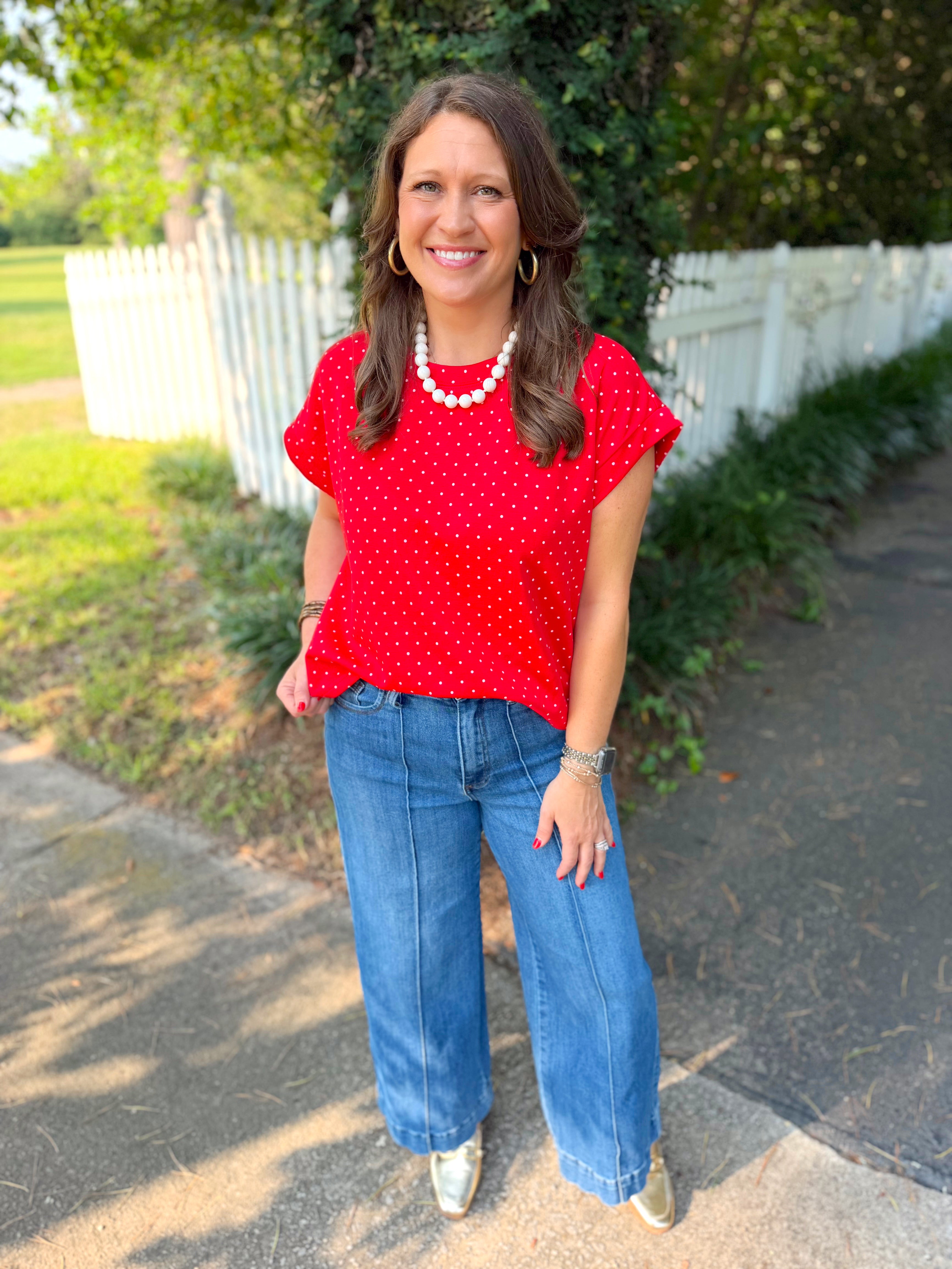 A red short-sleeve top with white polka dots.