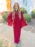 This dress features a rich cranberry red hue with delicate embroidered floral details throughout.