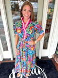 Vibrant floral dress with ruffle high neckline and cinching at the waist