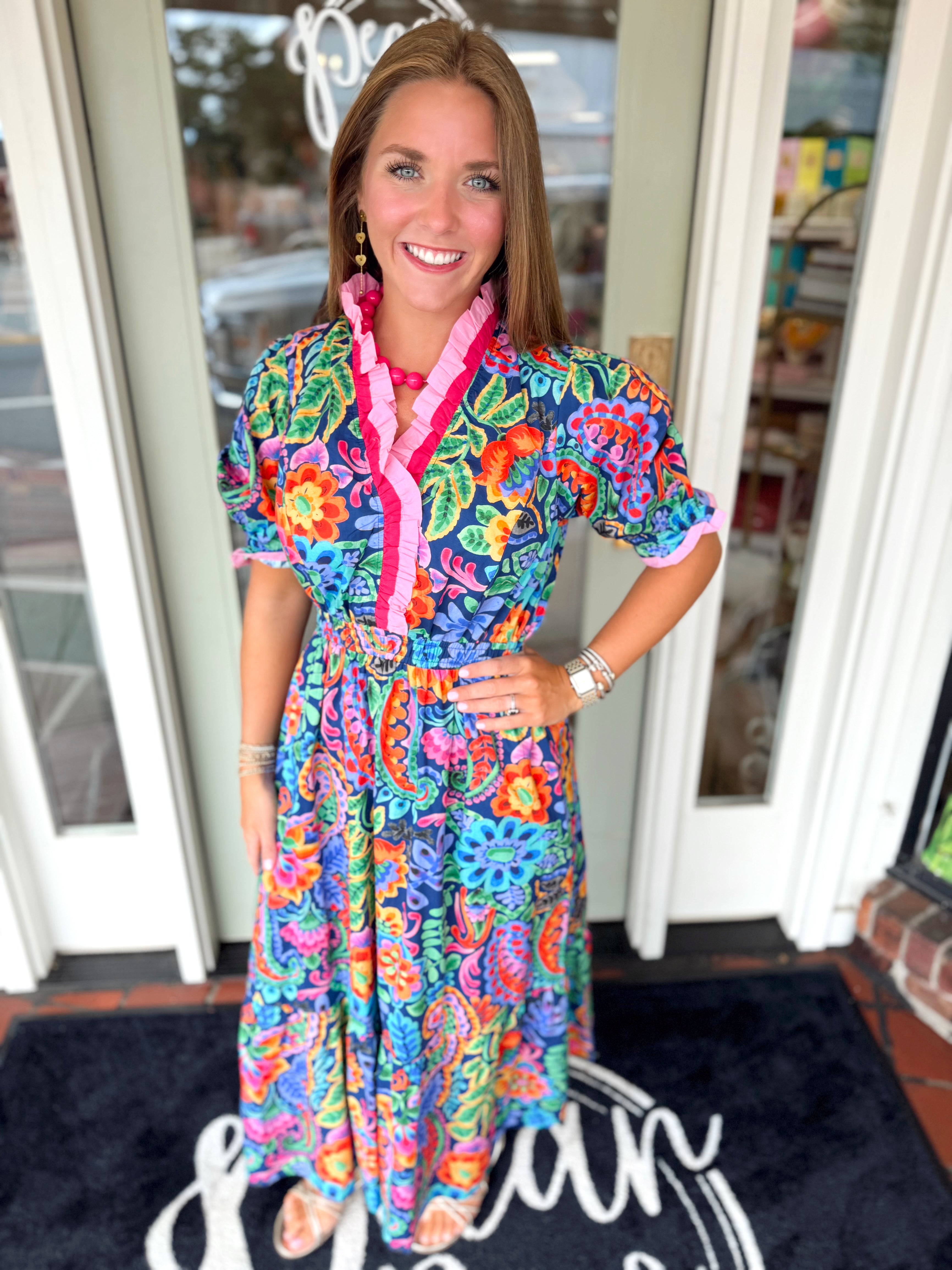 Vibrant floral dress with ruffle high neckline and cinching at the waist