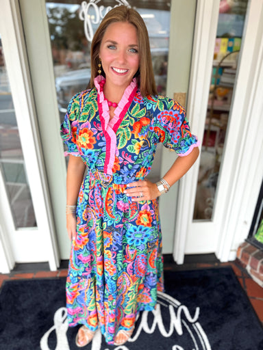 Vibrant floral dress with ruffle high neckline and cinching at the waist