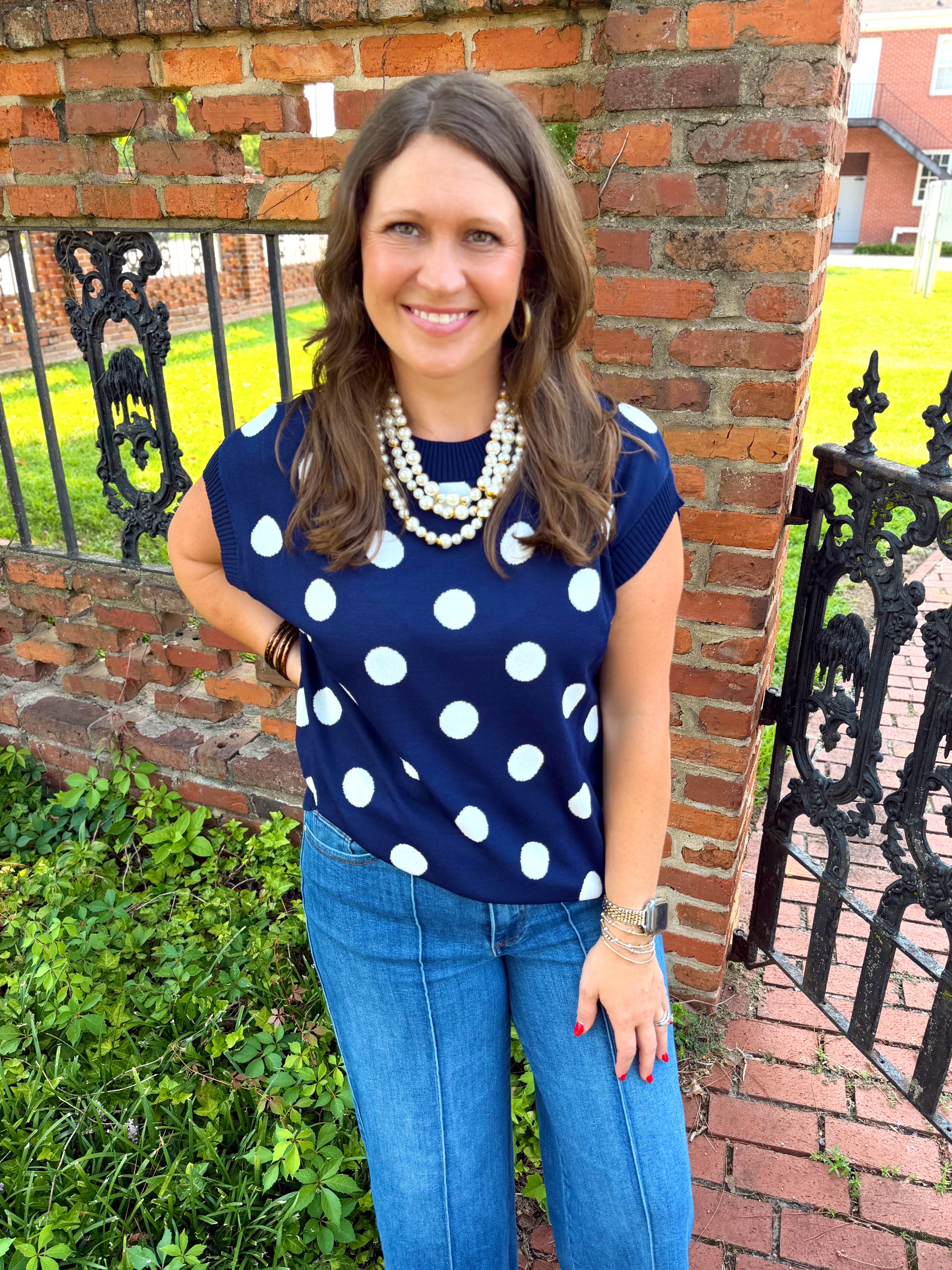 A navy blue short-sleeve top with white polka dots 