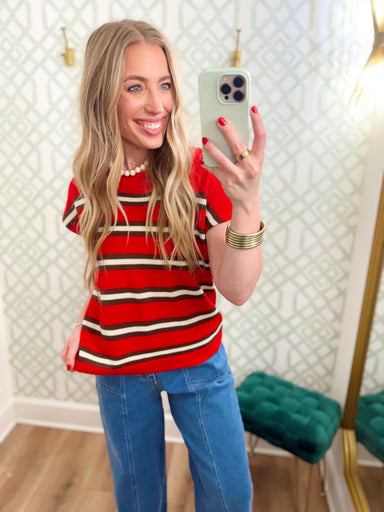  This top features a bright red knit with classic brown and ivory stripes for a sporty, retro-inspired look. 