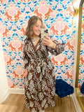 This brown midi dress features an oversized blue botanical print that gives it a fresh, elevated feel.