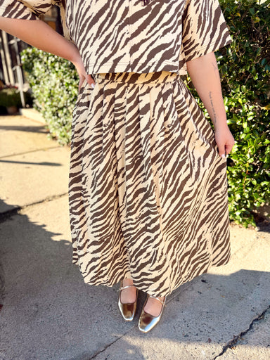 This cream and chocolate zebra print skirt features a full midi length with soft pleating that gives it plenty of movement and shape.