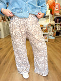  These leopard print pants feature a soft neutral color palette, comfortable elastic waistband, subtle pleating, and a flowy wide-leg silhouette. 
