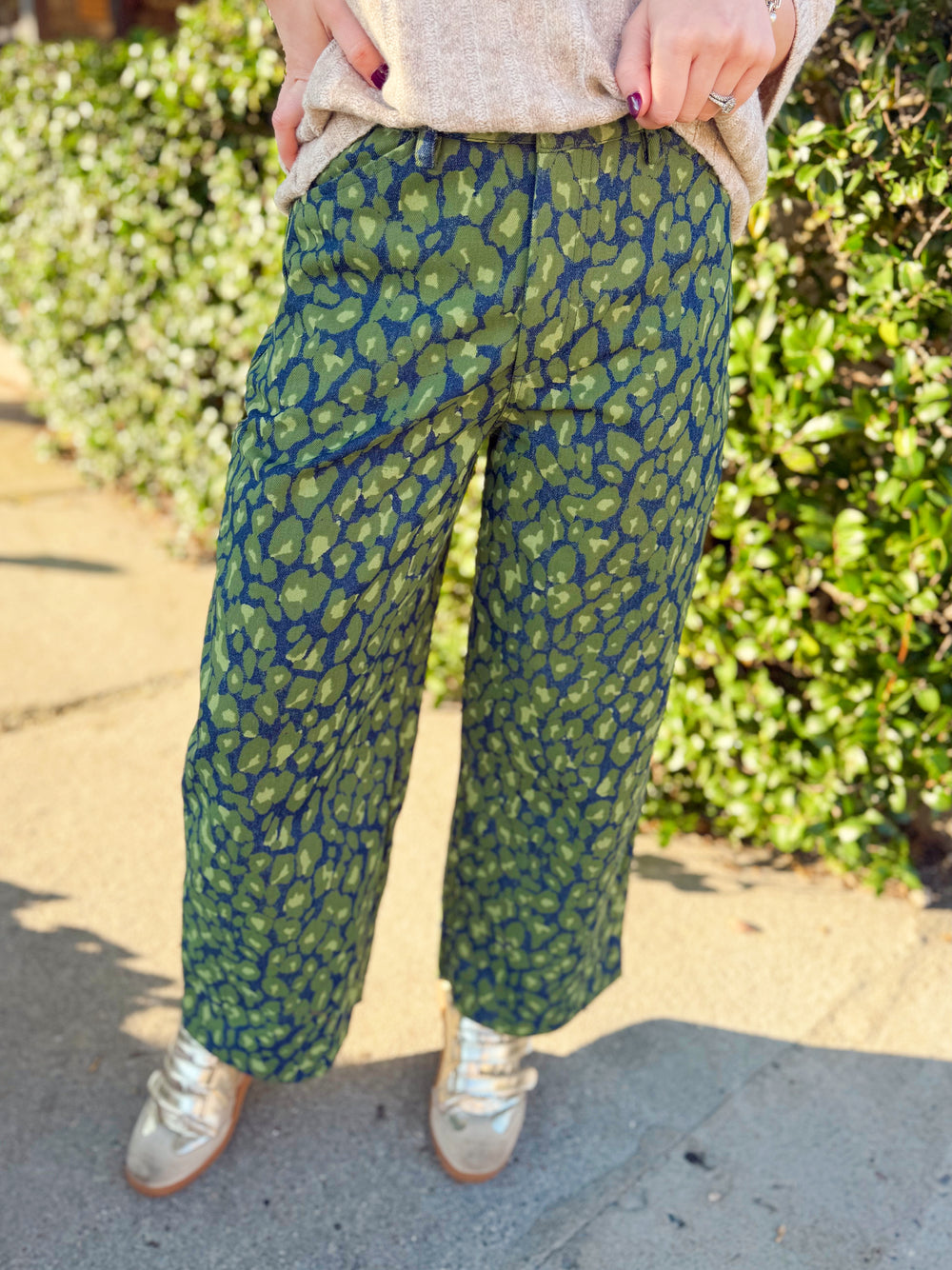 Green leopard denim pants with a barrel leg fit to them