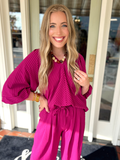 A bright fuchsia pink striped top with flowwy sleeves