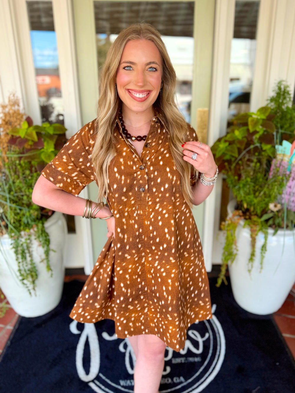 This animal print mini dress features a classic shirt collar, short cuffed sleeves and a button-down front for a polished touch.