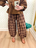  These pants feature a warm brown and tan plaid with a relaxed barrel-leg silhouette that gives them that easy, slightly oversized look we love. 