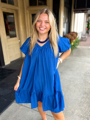 Bright royal blue short-sleeve dress with puff sleeves and a ruffled hem