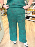Hunter green floral printed pants with a strip down the leg
