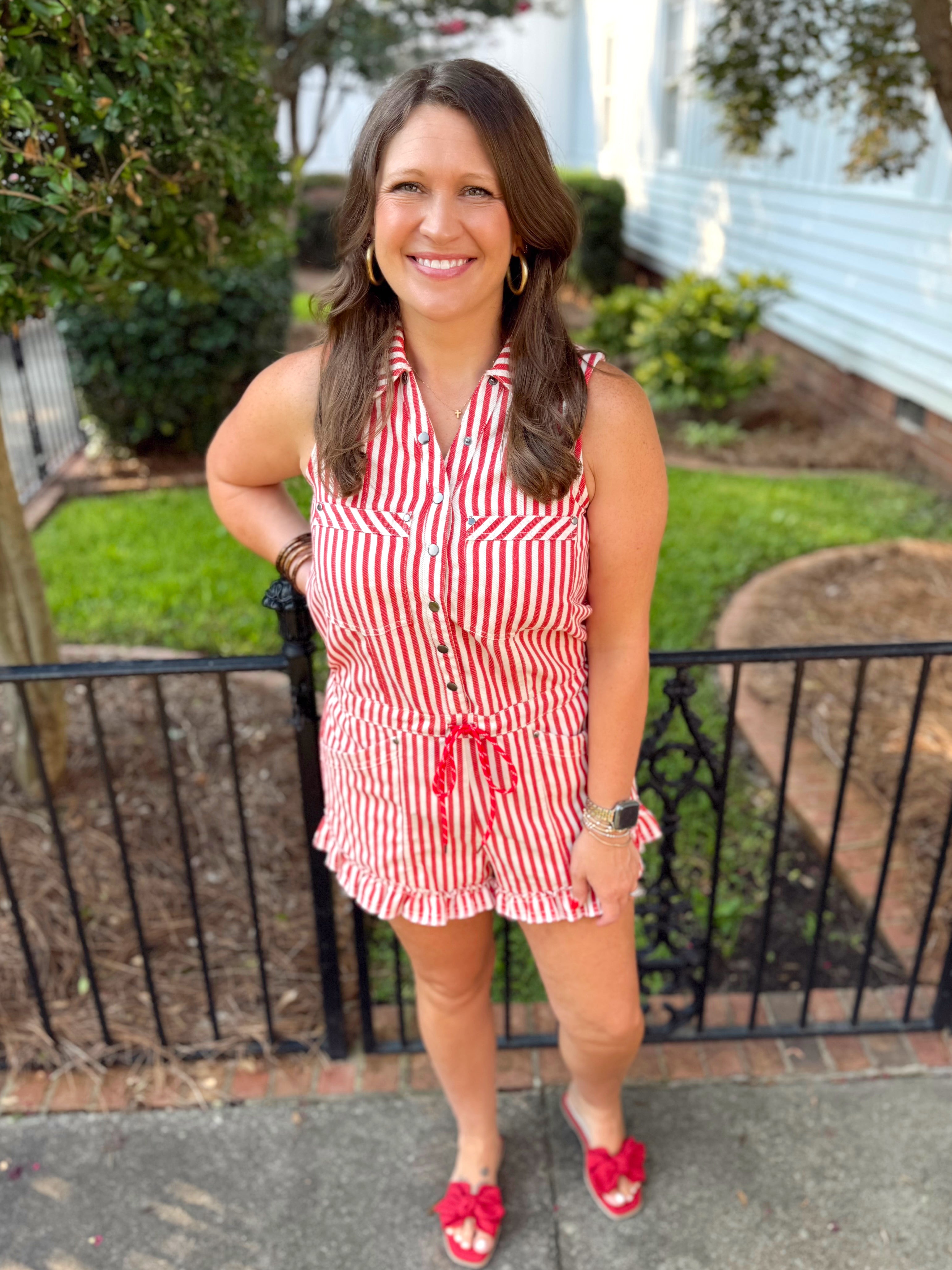 Red and cream striped sleeveless romper with ruffle detailing at the bottom.