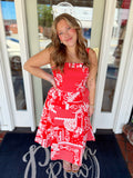 Woman wearing a red and white patchwork print midi dress with floral and gingham patterns, fitted bodice, and flowy skirt.