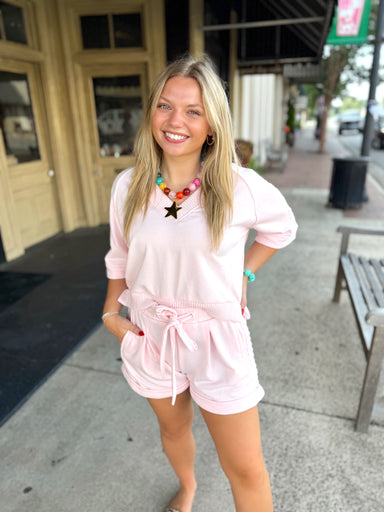 A short-sleeve V-neck knit trim top