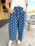Loose blue pants with a white polka dot pattern and a matching drawstring waist.