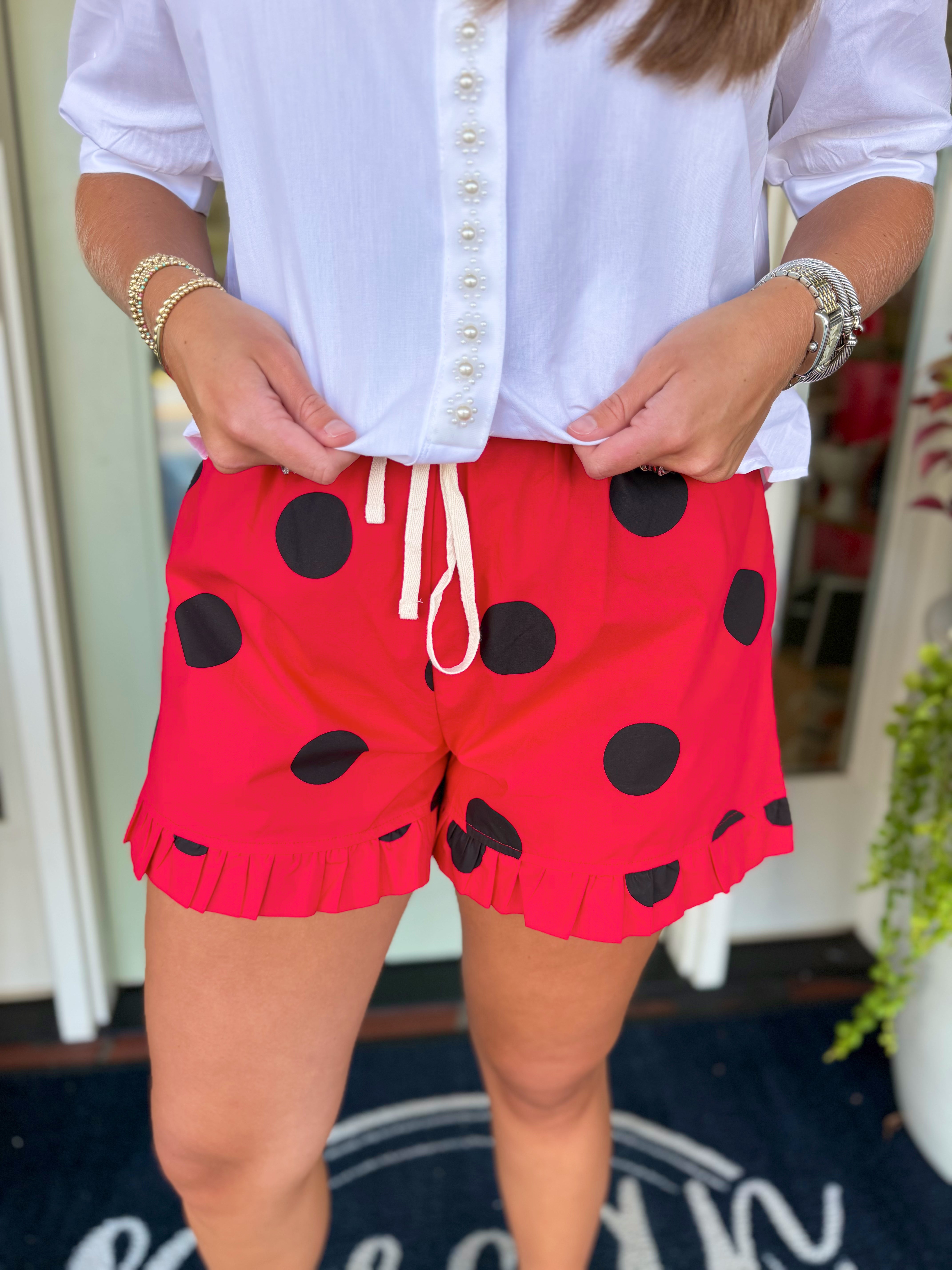 Red ruffled shorts with large black polka dots and a white drawstring