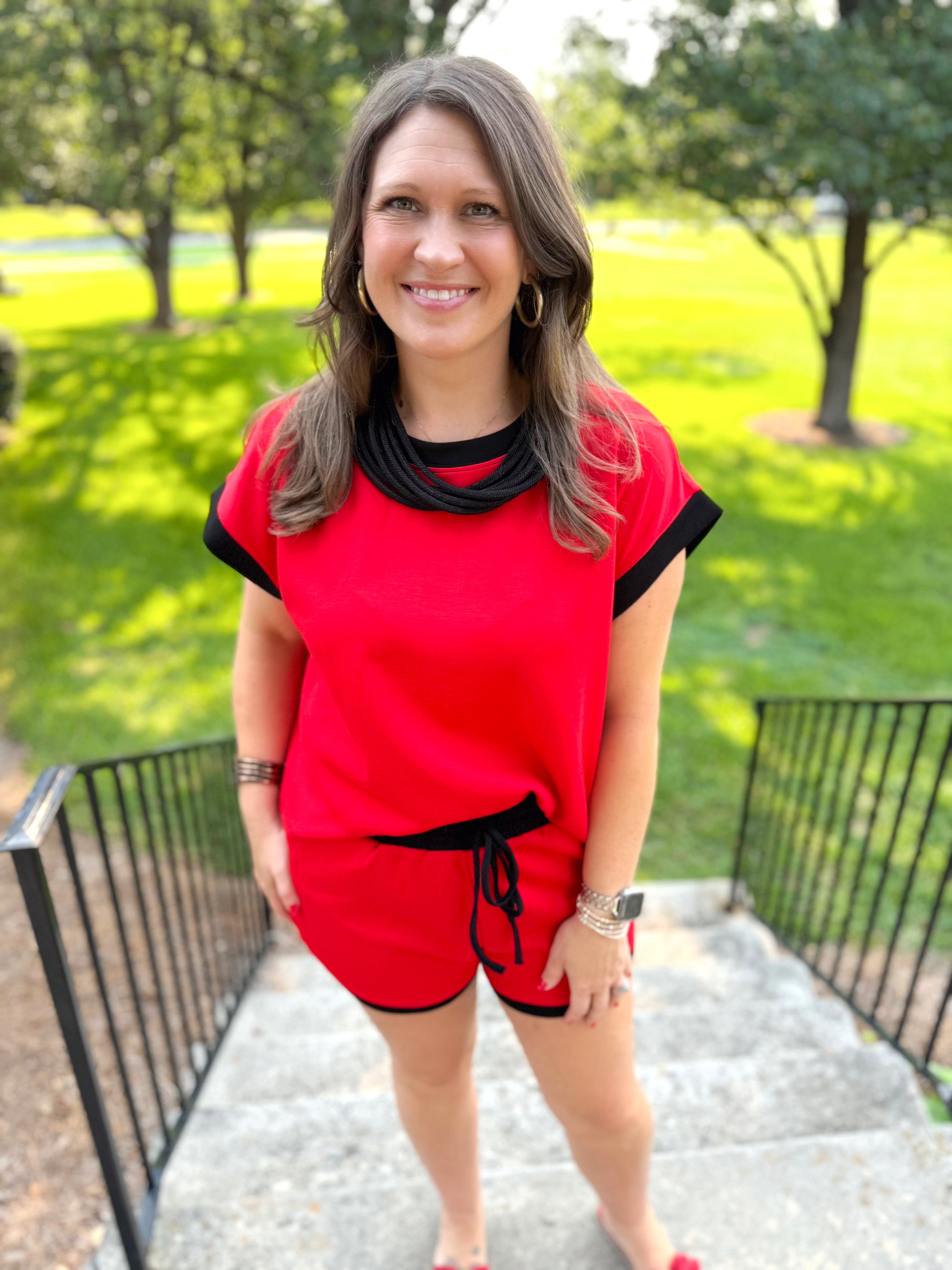 A red short-sleeve top with black trim.