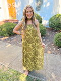 This dress features a rich martini green hue with a strapless neckline and flowing maxi silhouette.
