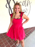 A red sleeveless dress with black trim and ruffled shoulder details