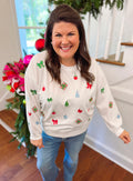 white sweatshirt with Christmas items on the front 