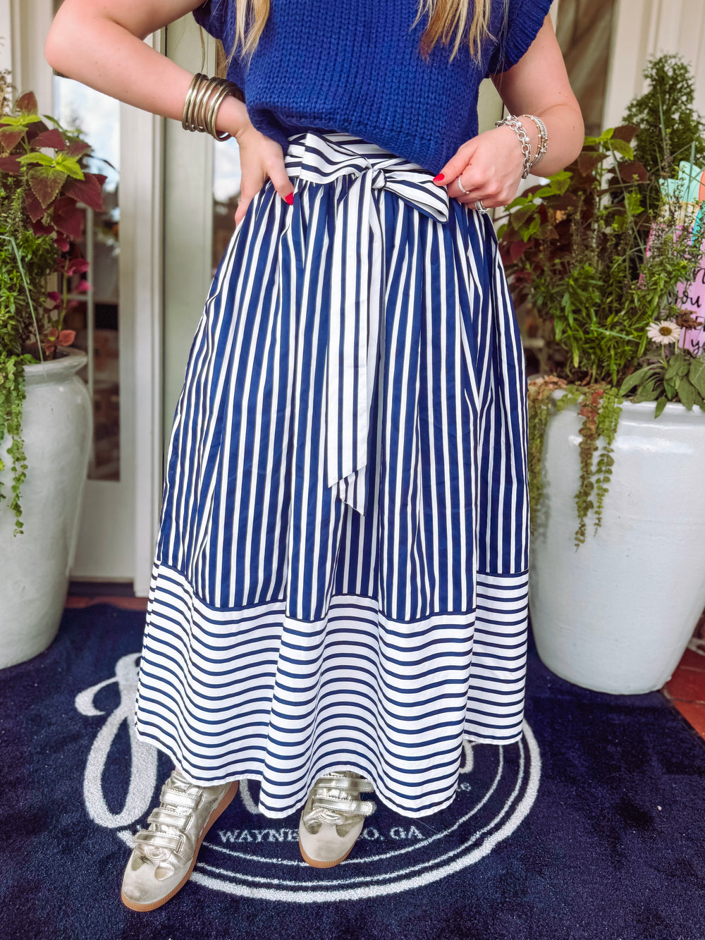 Navy and white striped skirt with a zipper on the side finish with an adjustable tie bow detailing on the front 