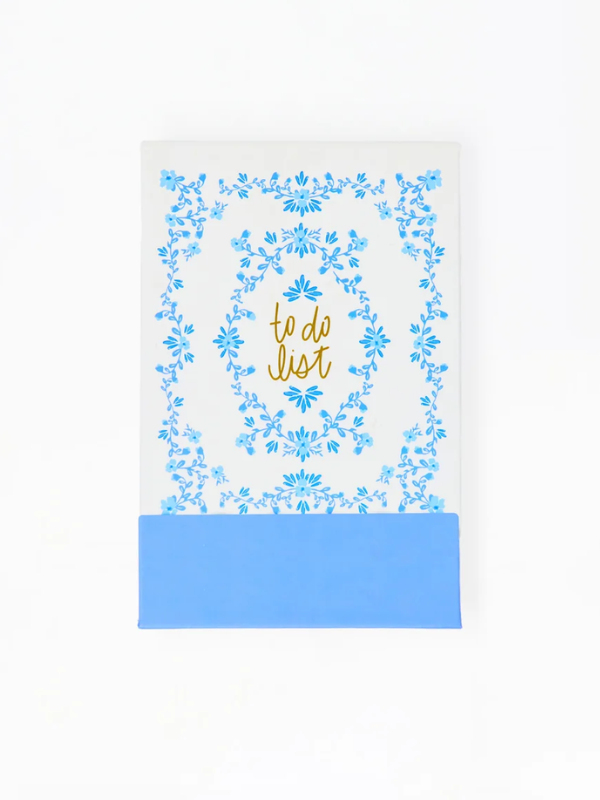 Notebook with floral design and 'to do list' text on a white background