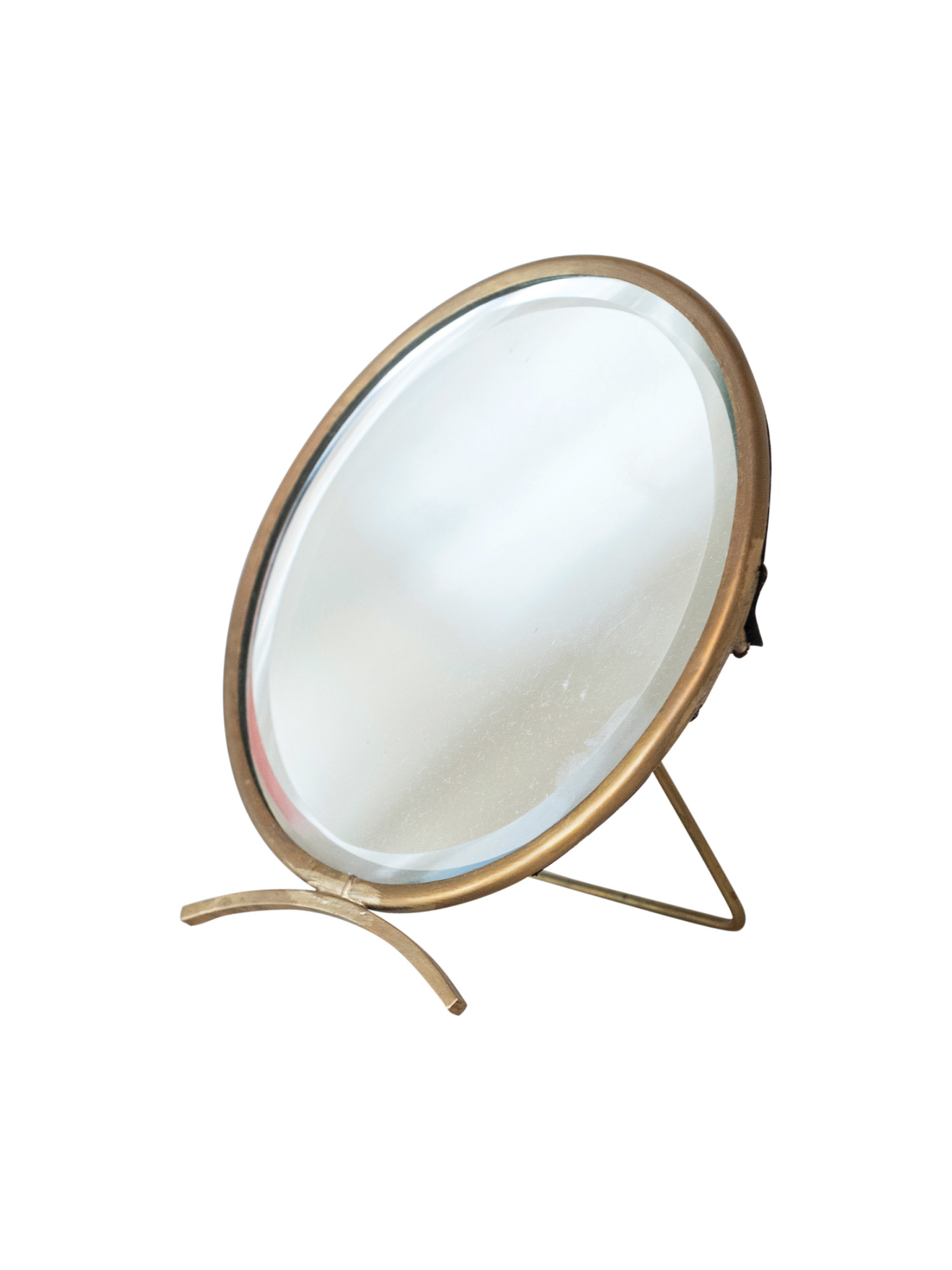 Round tabletop mirror with an antique brass frame and freestanding curved base, perfect for vanities, dressers, bathrooms, and decorative shelf styling.
