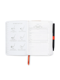 Open notebook with golf-themed pages and a pen
