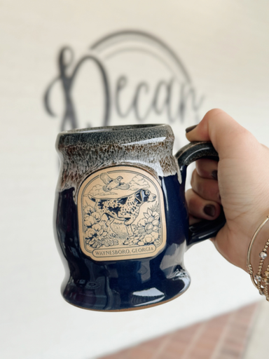 blue coffee mug with a froty narrow rim with a bird dog on it 