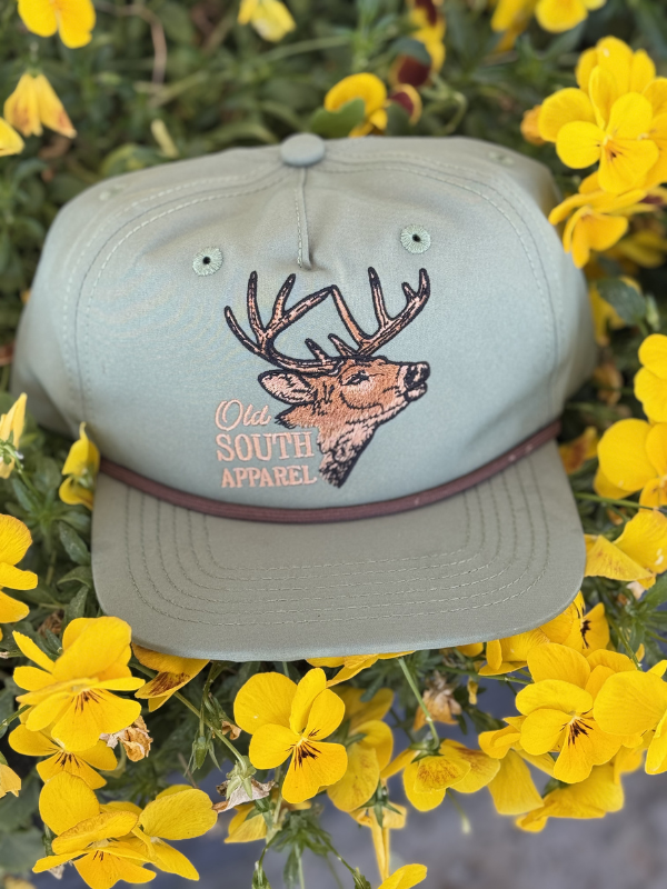 buck head on a green moss youth trucker hat